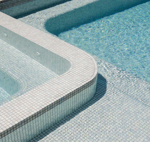 Compact concrete pool and spa with a clean waterline beside a Melbourne home