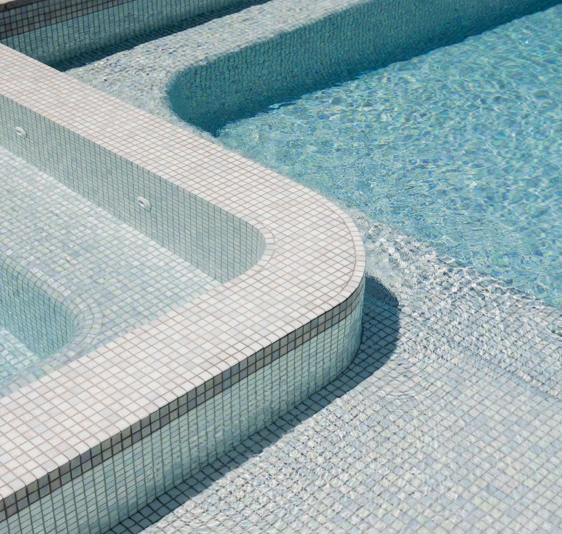 Compact concrete pool and spa with a clean waterline beside a Melbourne home