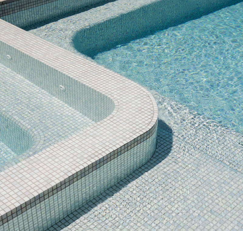 Compact concrete pool and spa with a clean waterline beside a Melbourne home