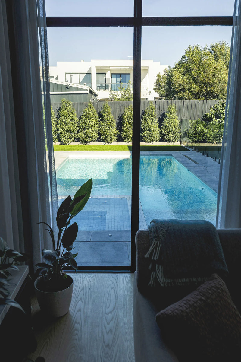 Altona concrete pool and spa through glass by Fine Art Pools